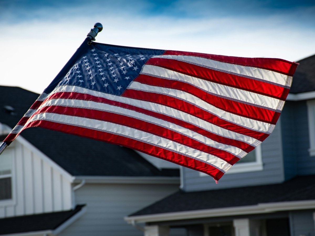 A heritage site coordinator in Richmond interviewing a stamp collector, checking the archival quality of 1,000-unit coils of USPS collectible stamps.