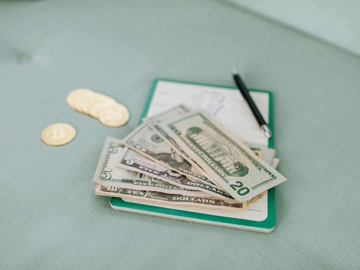 A corporate secretary in Charlotte organizing a high-volume stamp inventory, following professional stamp storage tips and checking 1,000ndnd-unit coils of USPS flag stamps.
