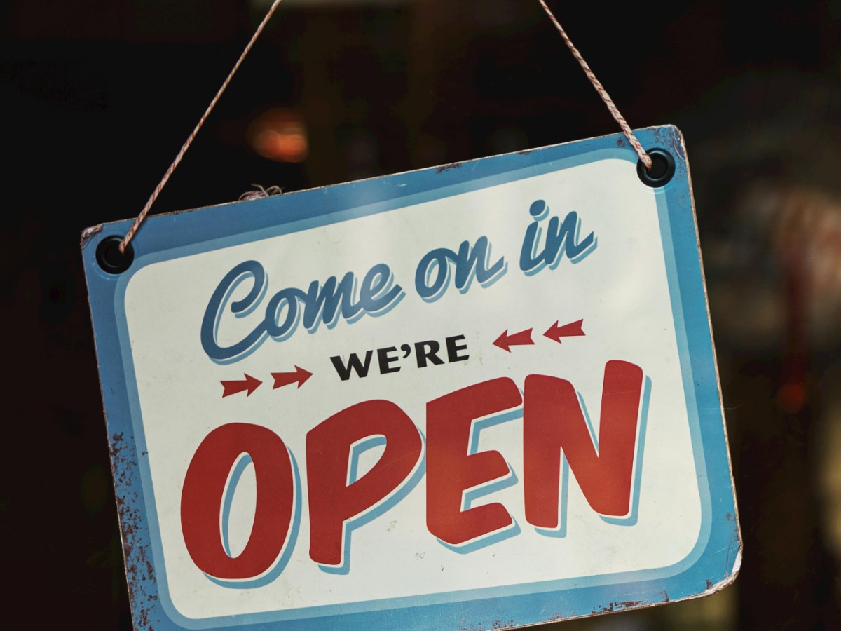 A real estate operations lead in a Phoenix office auditing a batch of escrow packets and applying forever stamps from the usps postage stamps online store with the city skyline in the background.